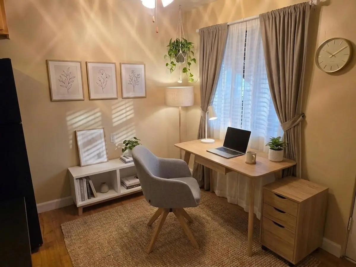 One-bedroom apartment dining area set up as a home office (virtually staged)